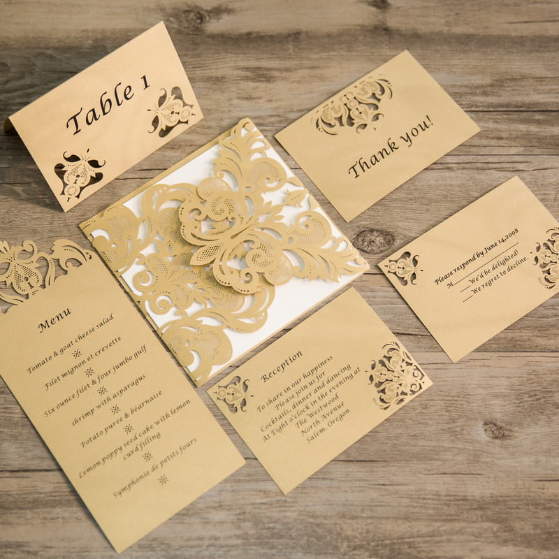A gold wedding invitation set with a place card and a stationery store.