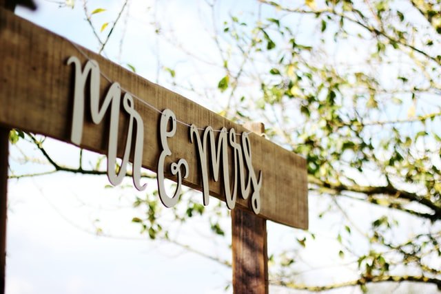 A wooden sign with "Mr. and Mrs." written on it, perfect for Texas wedding invitations or san antonio invitation printing.
