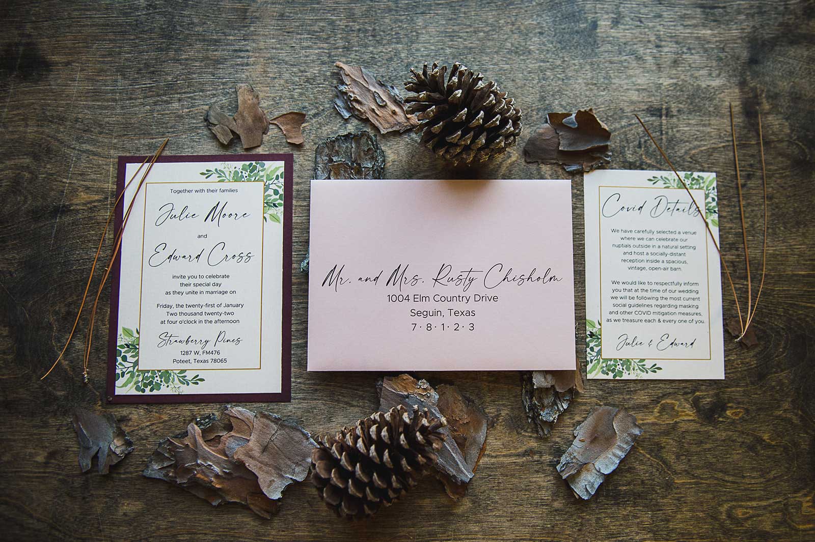 pink and cream wedding invitation suite with pinecones