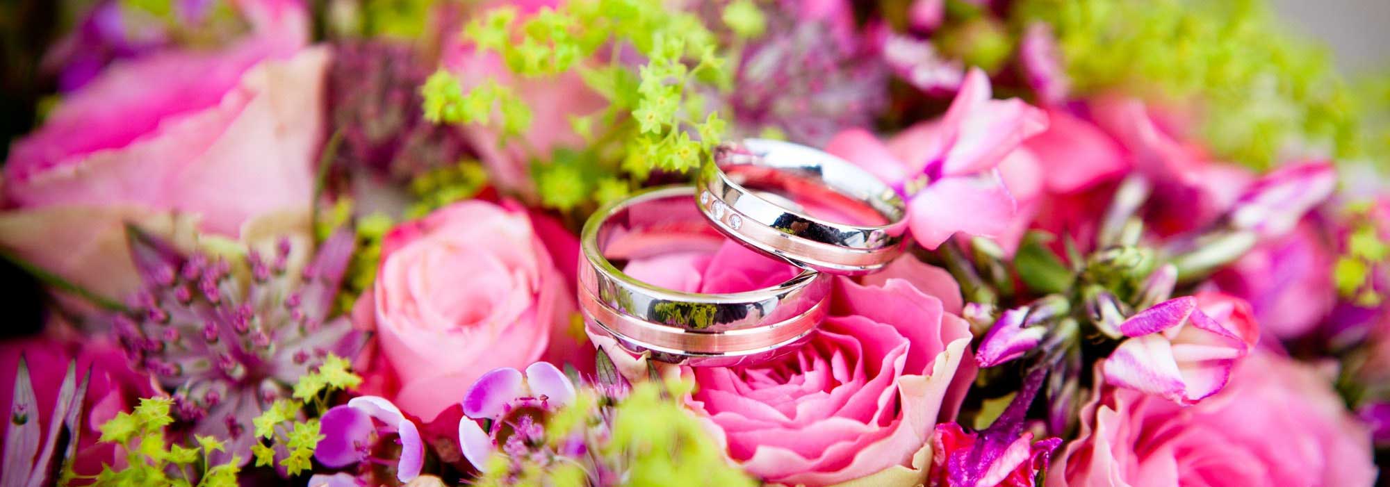 Keywords: wedding rings, pink flowers