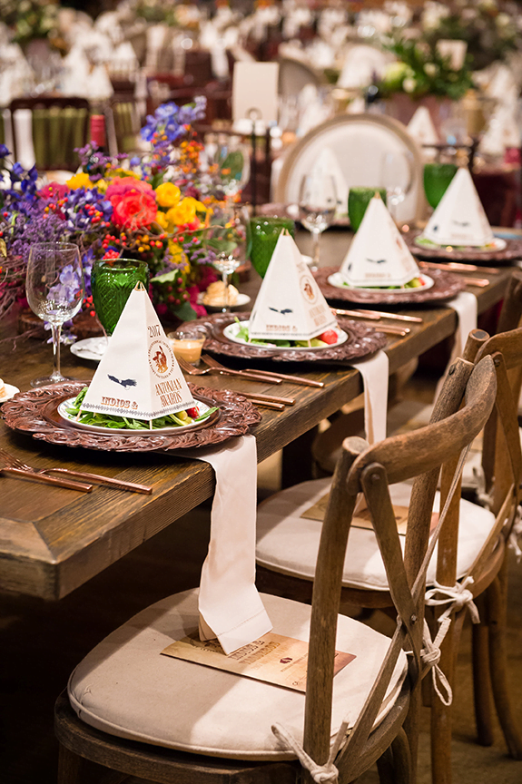 A long wooden table is set up for a dinner party in a san antonio stationery store.