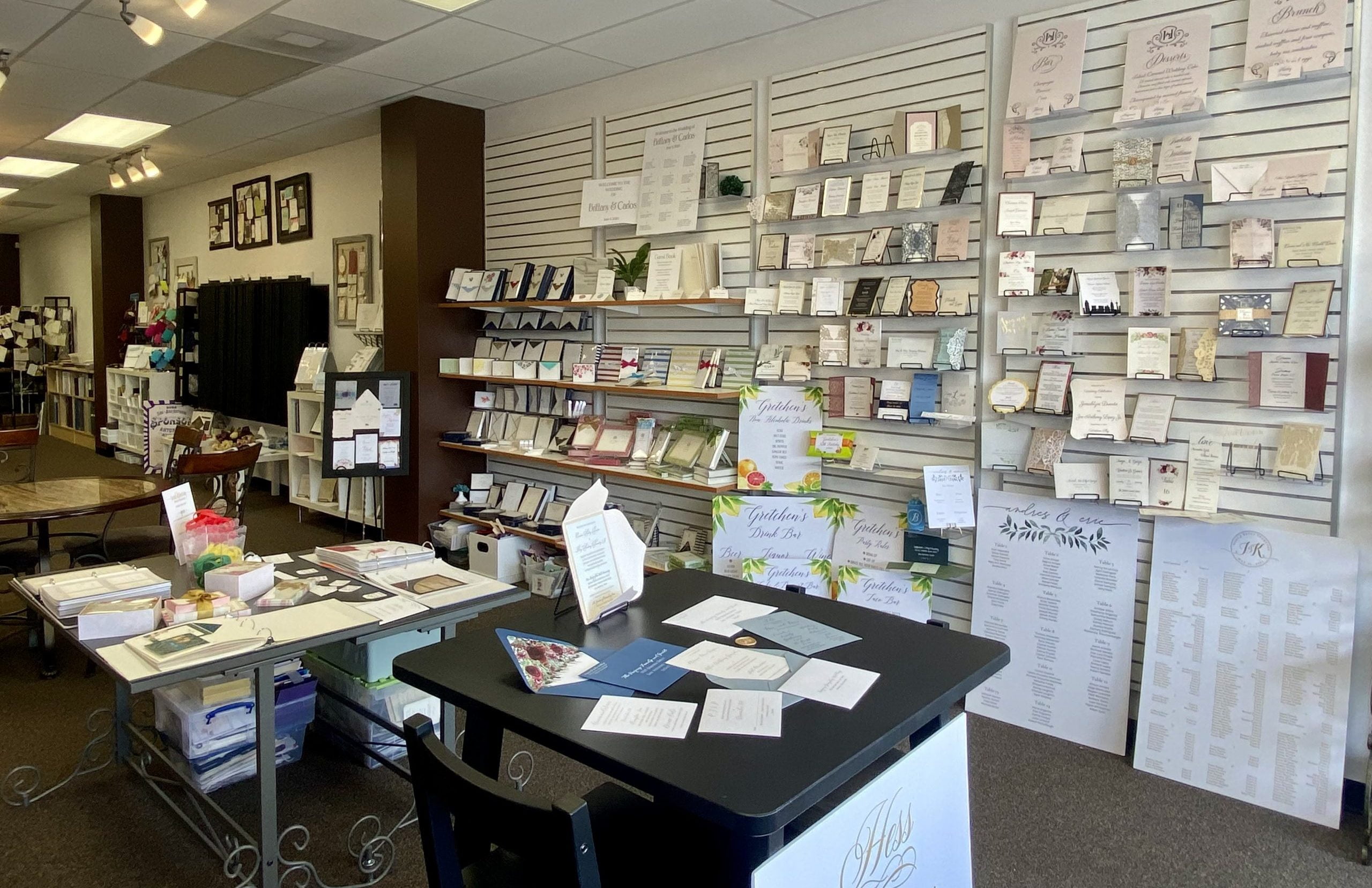 A san antonio store with a lot of paper and cards on the wall, specializing in invitation printing and stationery.